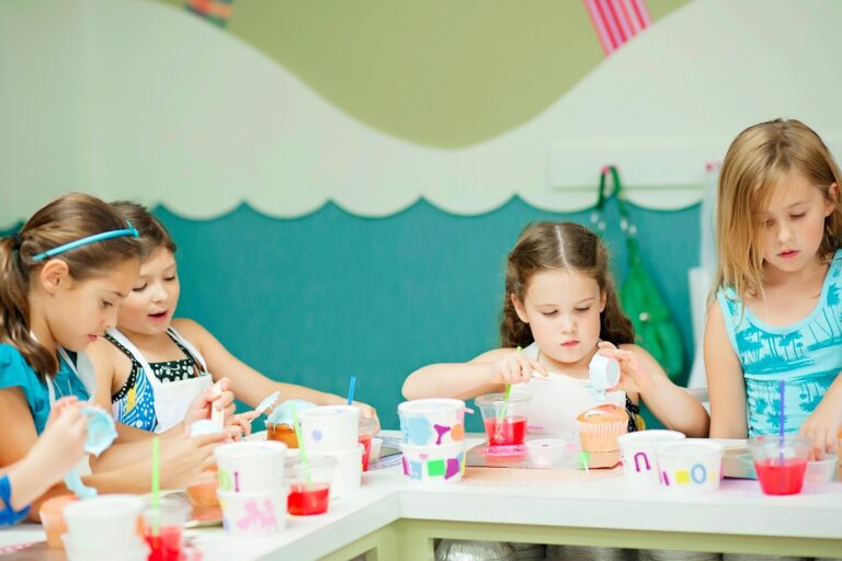 Young kids decorating cupcakes at a Foodie Kids cooking class in Austin